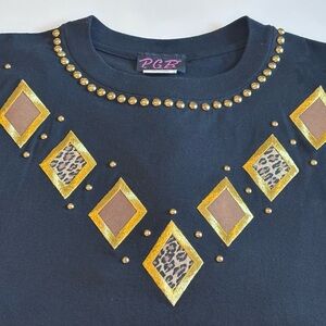 PGB Black Vintage T shirt with gold tone accents/embellishments. Size Large.